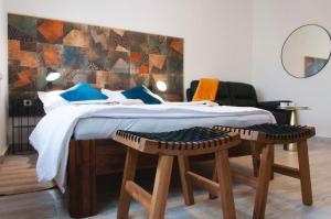 a bedroom with a bed with two stools at Work & Stay Zagreb in Zagreb