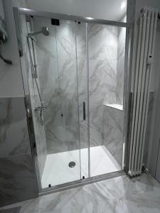 a shower with a glass door in a bathroom at Le Colonne Di San Luca in Genova
