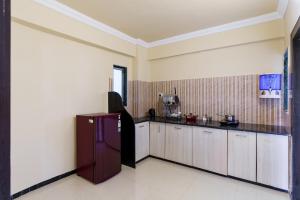 a kitchen with a purple refrigerator in a room at Lazy Daze by UCH in Udaipur