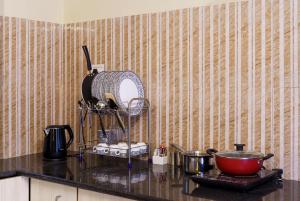 a kitchen counter with a mixer and a bowl on a counter at Lazy Daze by UCH in Udaipur