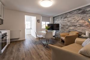 a living room with a couch and a table at Villa Helga- Ferienwohnung Abendmond mit Terrasse und 2 Schlafzimmern in Zinnowitz +7 photos
