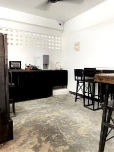 an empty room with a piano and a desk at Sleep Owl Chiang Mai in Chiang Mai