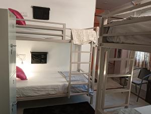 a room with two bunk beds and a television at Bonjour Travellers Hostel in Hyderabad