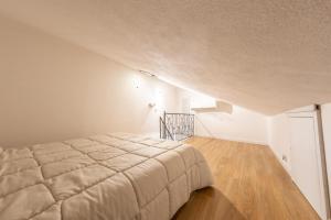 a bedroom with a bed and a staircase at Casa Argo Guest House in Bisaccia