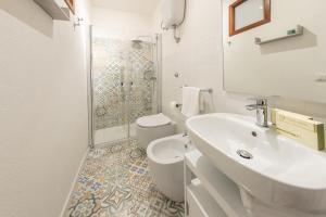 a bathroom with a sink and a toilet and a shower at Casa Argo Guest House in Bisaccia