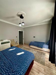 a bedroom with a blue and white bed in it at Ekinci Plaza in Istanbul