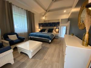 a bedroom with a bed and a living room at Villa face mer in Royan