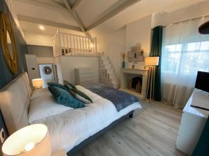 a bedroom with a large bed with pillows on it at Villa face mer in Royan