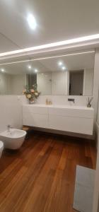 a bathroom with a tub and a sink and a mirror at S.Soares T3 Expo Sul in Lisbon