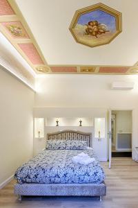 1 dormitorio con 1 cama y una pintura en el techo en Casa Ciseri, en Siena