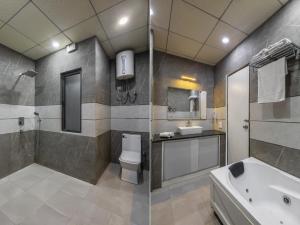 a bathroom with a sink and a toilet and a tub at Shree Jee Hotel - NIT Faridabad in Faridabad