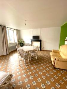 a living room with a table and a couch at Maison chaleureuse à Audignies avec stationnement privé in Audignies