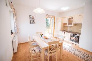 a kitchen and dining room with a table and chairs at Rogla Alpina Residence in Zreče