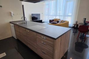a kitchen with a sink and a counter top at Smart Stay Salmiya apartment in Kuwait
