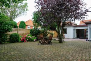 a patio with a table and chairs in a yard at BB-Hotel Frederikshavn Turisthotellet in Frederikshavn