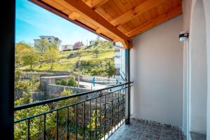 a balcony with a view of a hill at Fabio Guest House in Gjirokastër