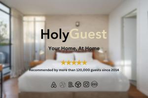 a sign that says holy guest your home at home at Modern 2BR Private House Neve Tsedek by HolyGuest in Tel Aviv