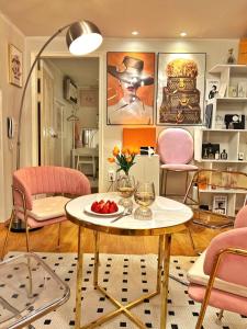 a living room with a table and pink chairs at Boutique,seoul in Seoul