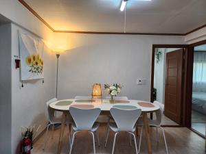 a dining room with a white table and chairs at Green Home Stay in Seoul