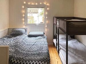 a bedroom with two bunk beds and a window at Holiday home Mönsterås VII in Mönsterås