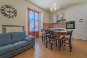 a living room with a couch and a table and chairs at Casa Federica - Goelba in Marciana Marina