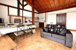 a living room with a couch and a kitchen with a table at Villa Micaela in Lamadrid