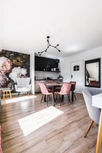 a living room with a dining room table and chairs at Apartamenty Krupówki 48B in Zakopane