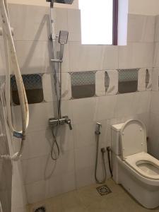 a bathroom with a shower and a toilet at R&R residencies in Mount Lavinia