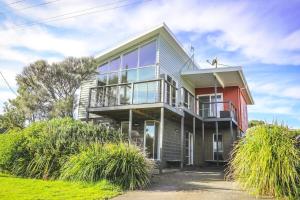a large house with a balcony on top of it at Pitcher Vista in Port Campbell