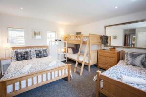 a bedroom with two beds and a bunk bed at The Roof Terrace Maisonette - City Centre in Bath