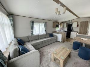 a living room with a couch and a table at Dog and Duck Leisure Park in Kent