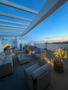 a rooftop patio with couches and lights at night at Amazing Penthouse in Costa del Sol in Rincón de la Victoria