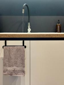 a kitchen counter with a sink and a towel at Maya Suites N.Moudania in Nea Moudania