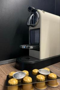 a coffee machine with donuts on a tray at Maya Suites N.Moudania in Nea Moudania
