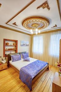 a bedroom with a large bed with a ceiling at Ardey Hotel in Istanbul