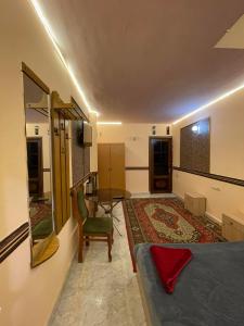 a bedroom with a bed and a mirror and a table at CITRUS Guest House in Yerevan