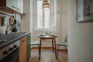cocina con mesa, sillas y ventana en Una casa a San Giacomo x2, en Trieste