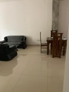 a living room with a couch and chairs and a table at R&R residencies in Mount Lavinia