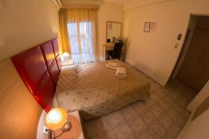 a bedroom with a bed and a desk and a window at Jolandas House in Toroni