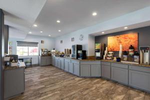 a coffee shop with a counter in a room at Days Inn & Suites by Wyndham Tucson/Marana in Tucson