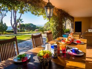 una mesa con comida y fruta en el patio en Villa Boreal, en Calonge