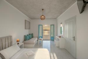 a living room with a bed and a couch at Nevma Suites in Firostefani