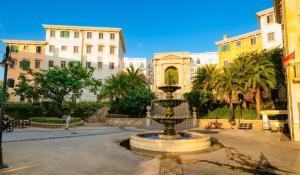 een fontein in het midden van een stad met gebouwen bij BELLA HOTEL PHU QUOC -Sunset Town, Địa Trung Hải- BIG PROMOTION 2024 in Phu Quoc