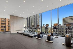 a gym with rows of tread machines in a building at A Comfy Apt Only a 5-min Walk to Victoria Market in Melbourne