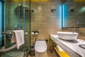 a bathroom with a toilet and a glass shower at Sky Hotel - Shenzhen Luohu Sungang BaoNeng Center in Shenzhen