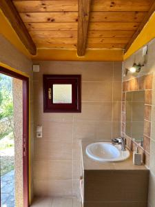 a bathroom with a sink and a window at Home · Makrades Corfu in Makrádes
