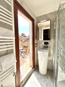a bathroom with a shower and a glass door at Hotel al Graspo de Ua in Venice +138 photos