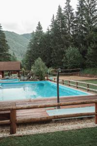 a large swimming pool with a wooden bench next to it at Jazierce in Ružomberok
