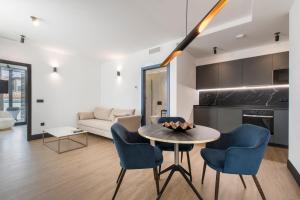 a living room with a table and chairs and a couch at RS Boutique Apartments in Alicante +45 photos