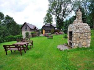 a park with picnic tables and a stone fireplace at Dom Polana Karpacz in Karpacz